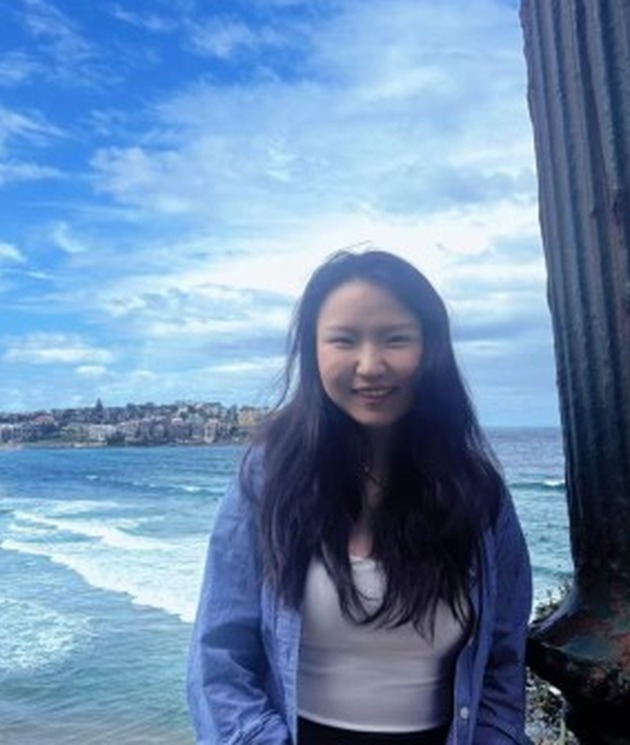 Weiwei Fu standing by the sea